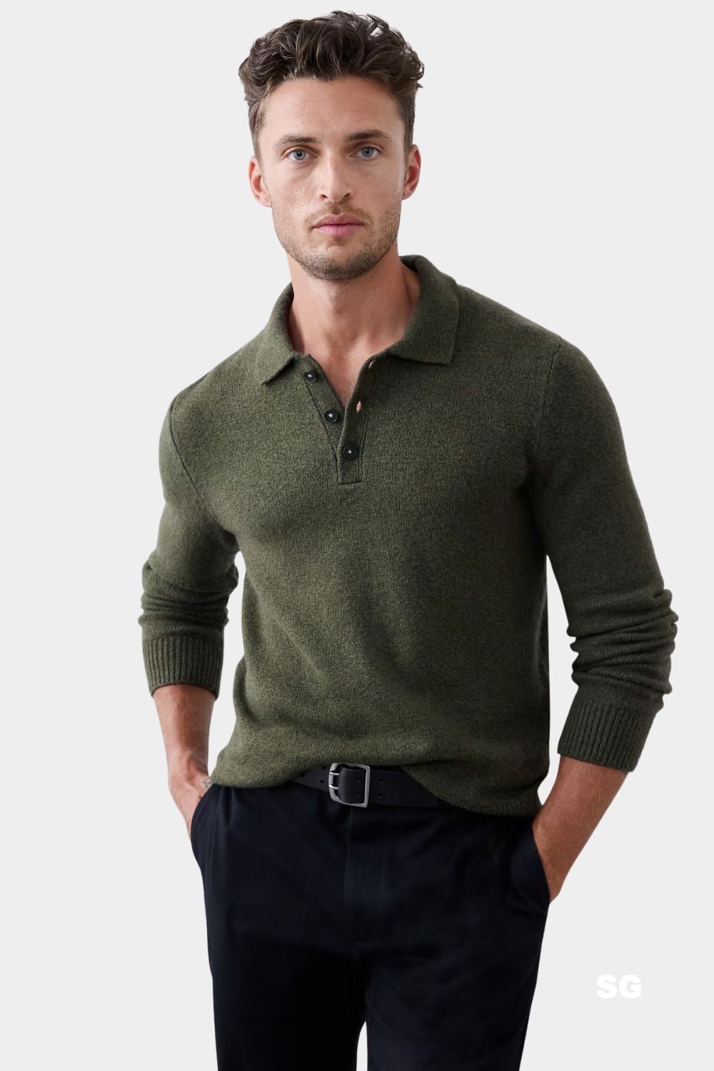 stylish man wearing an olive green long sleeve sweater polo with black trousers