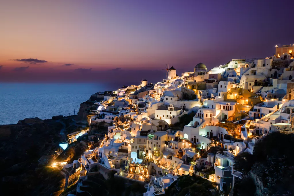 Santorini, Greece at sunset. Are these dream travel destinations on your bucket list? Discover the hidden gems that are seriously dream vacation destinations&hellip;and start packing!