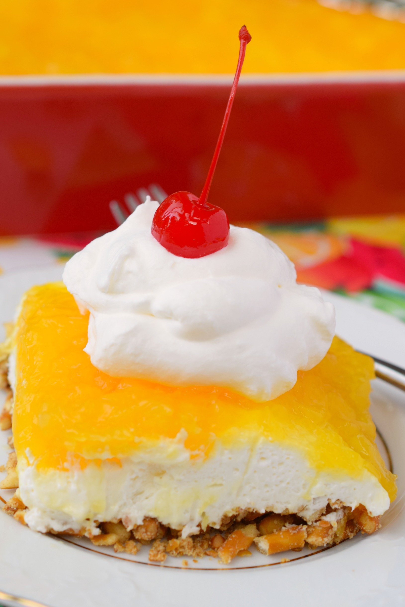 slice of dessert with whip cream and cherry on top