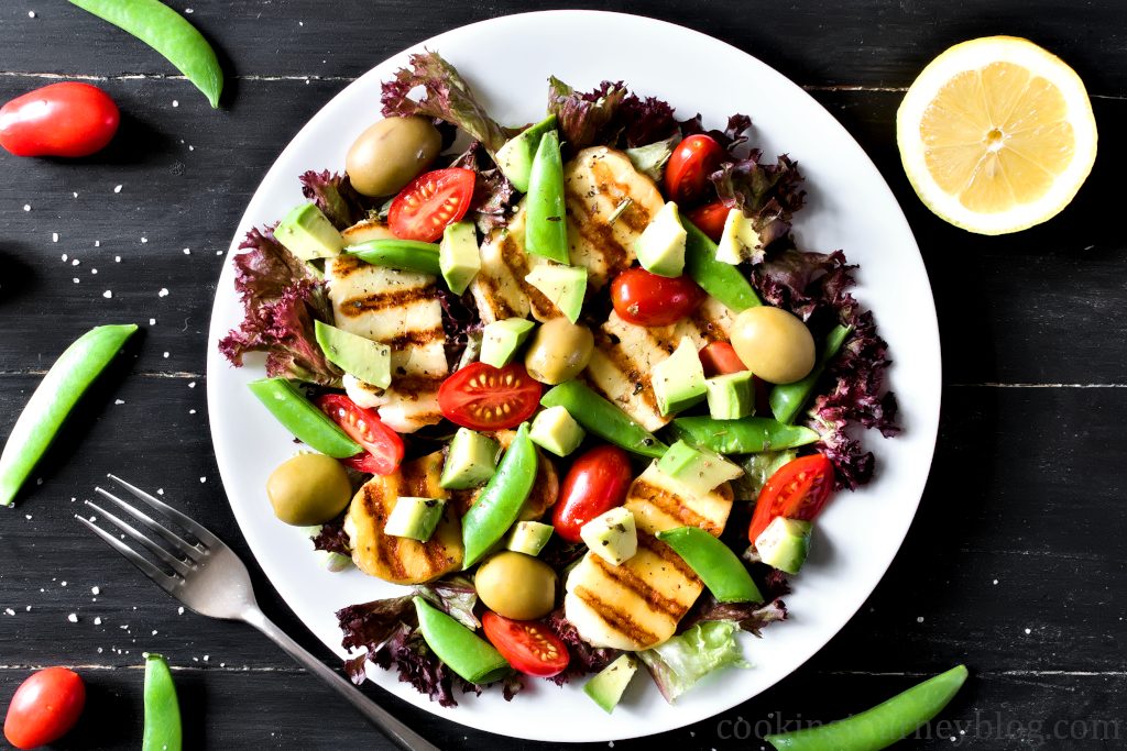 plate with grilled halloumi and avocado salad