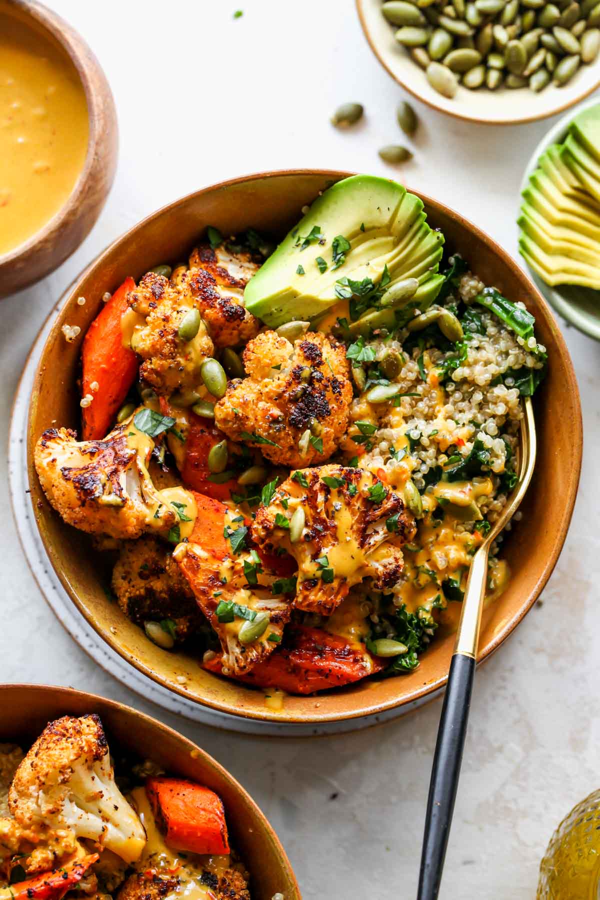 Roasted cauliflower and carrots over quinoa with golden tahini dressing
