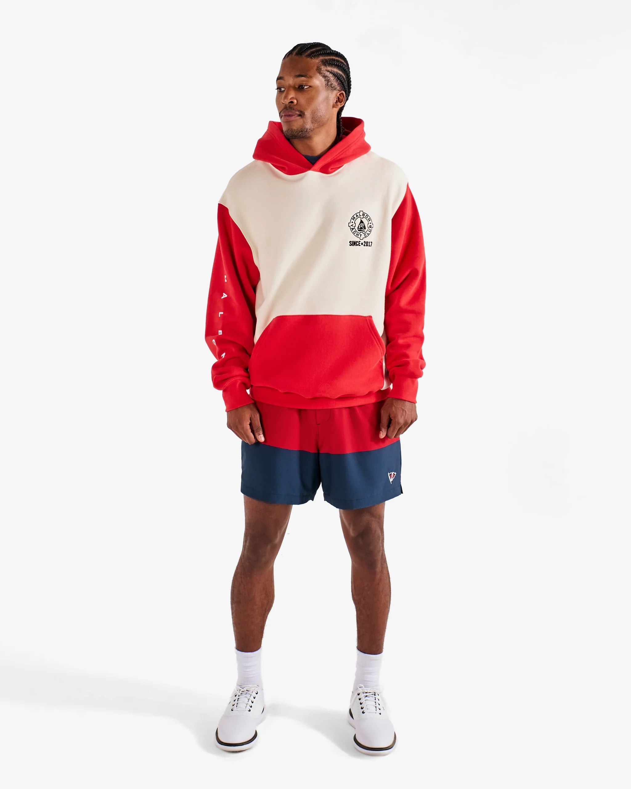 man wearing stylish red and white hoodie with red and blue shorts